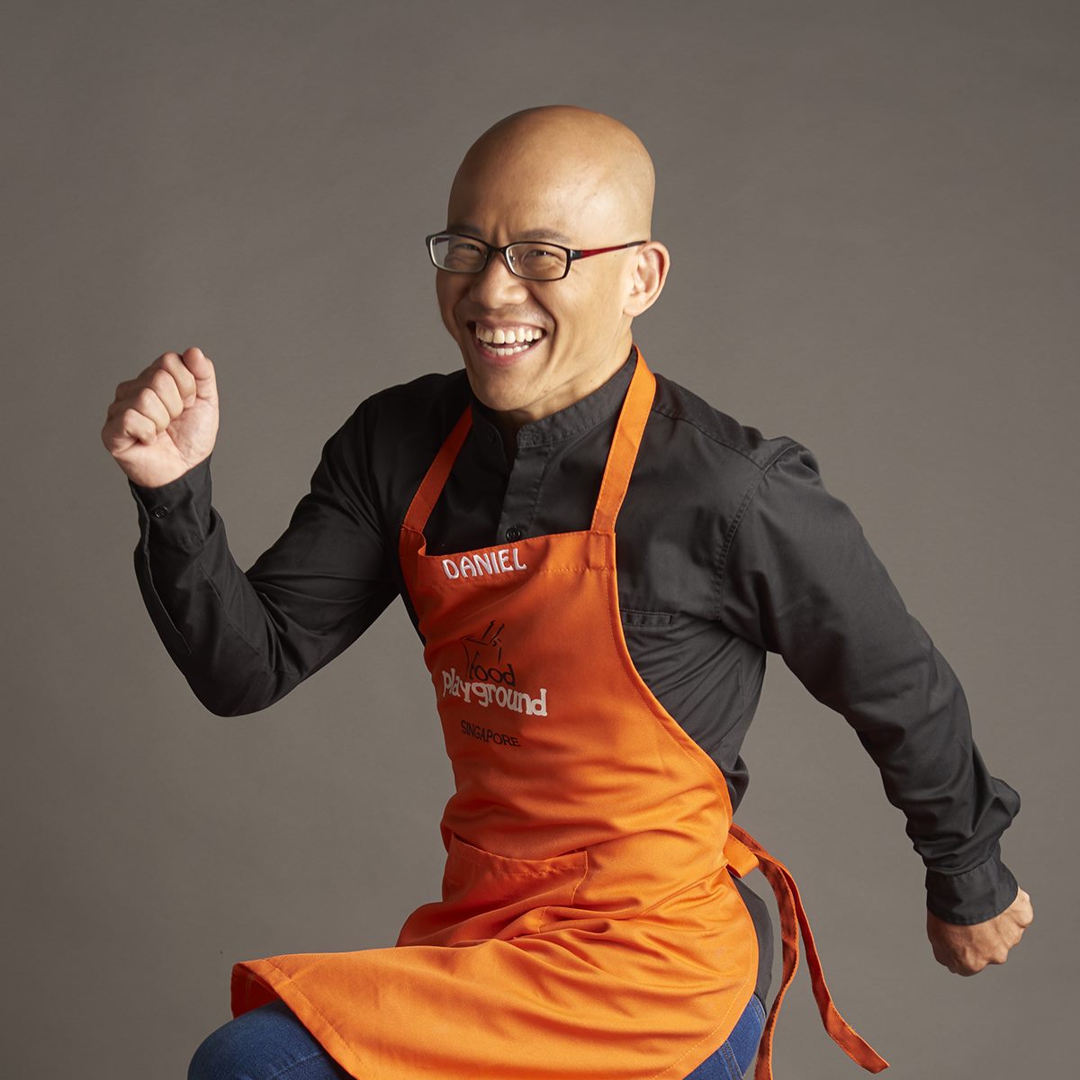 Daniel Tan in an orange Food Playground apron